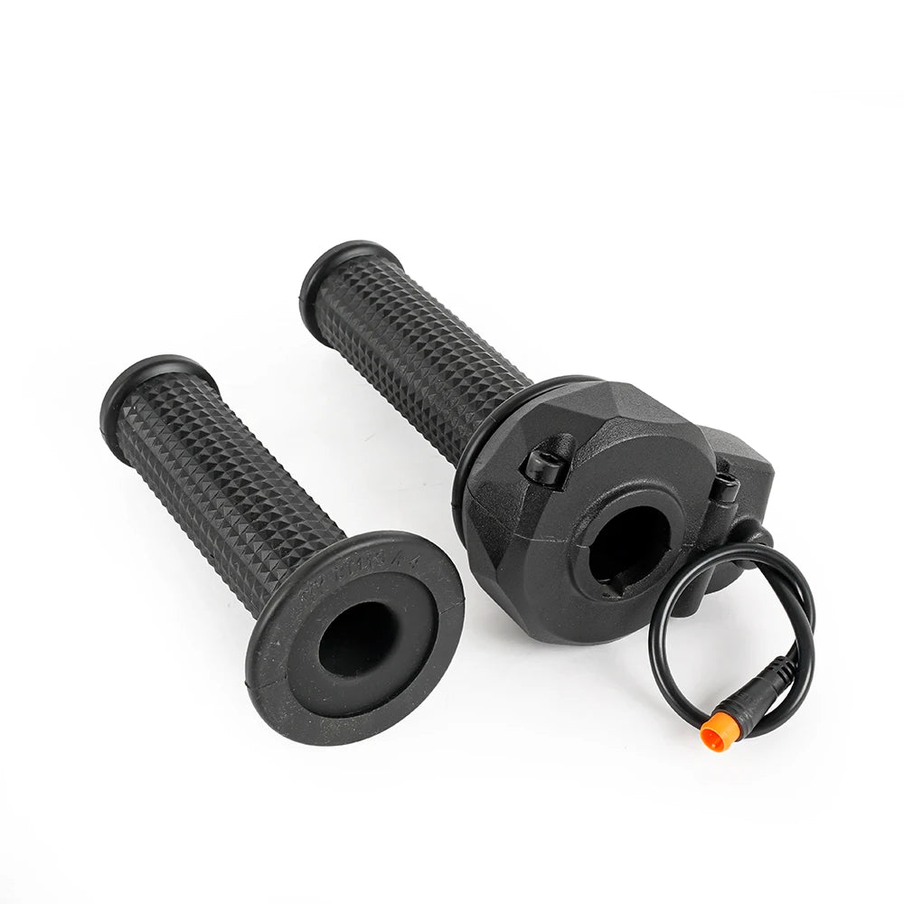 Throttle assembly and spare grip laid side by side, showing the adapter lead and orange connector