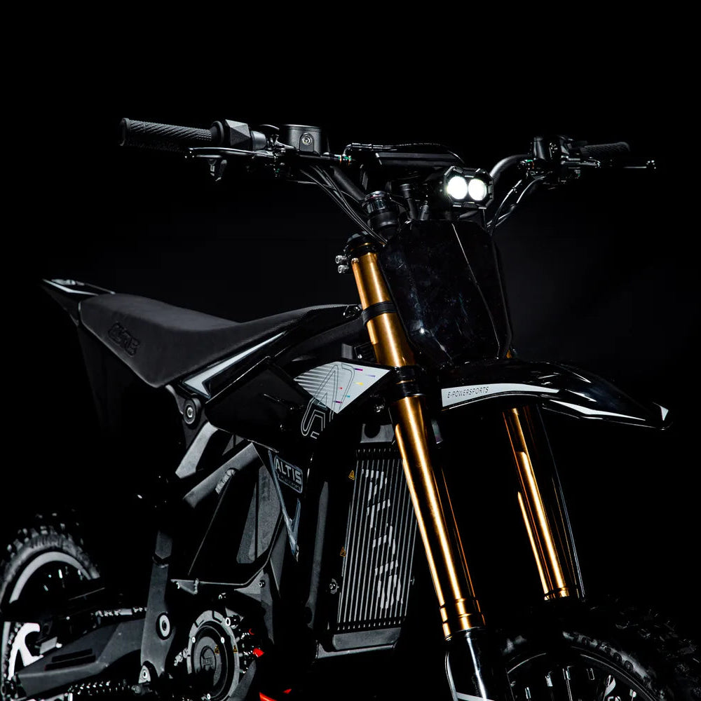 Front of the Altis Sigma with its twin LED headlights on, wide handlebars and gold fork tubes