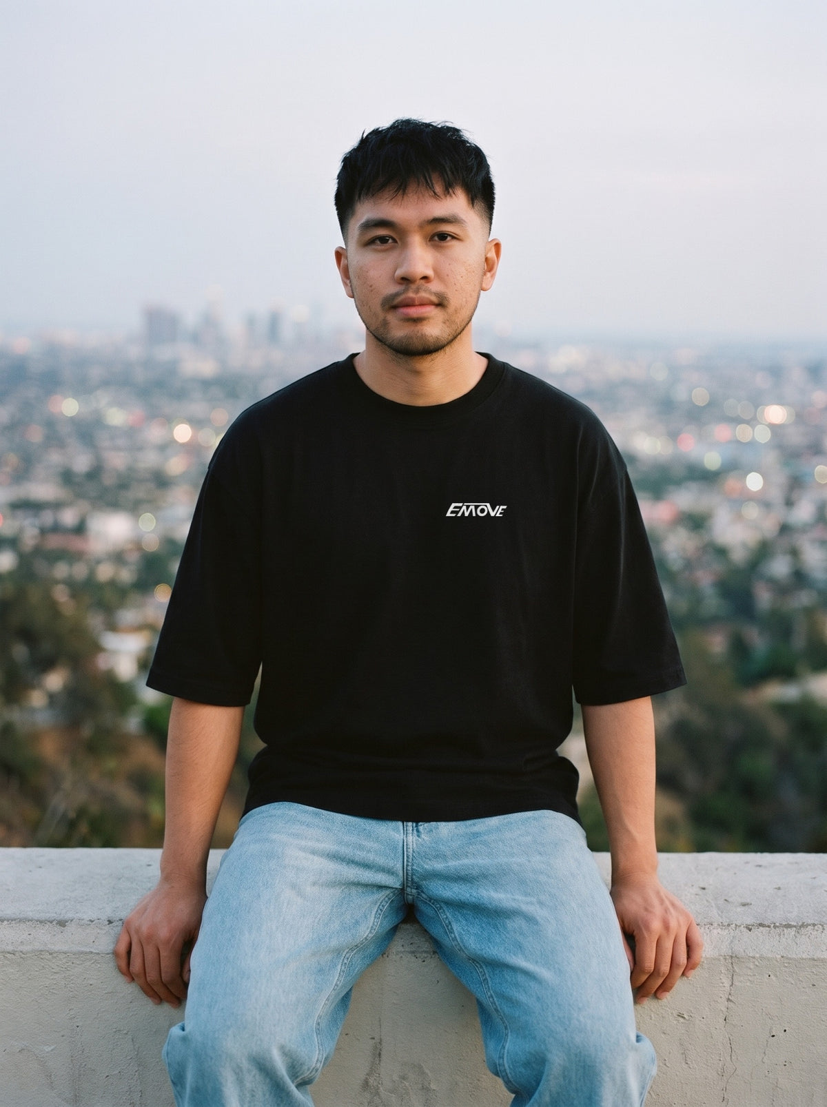 EMOVE Logo Tee in black worn by a man, EMOVE logo printed on the left chest