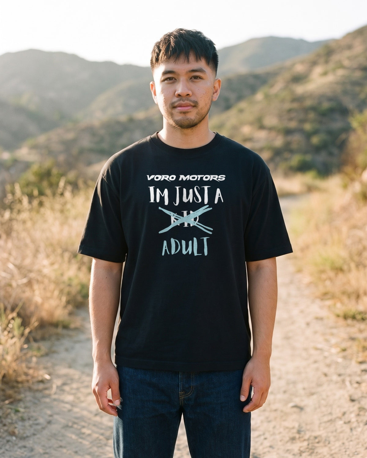 Man in the I'm Just a Kid Adult tee on a trail in the Angeles National Forest
