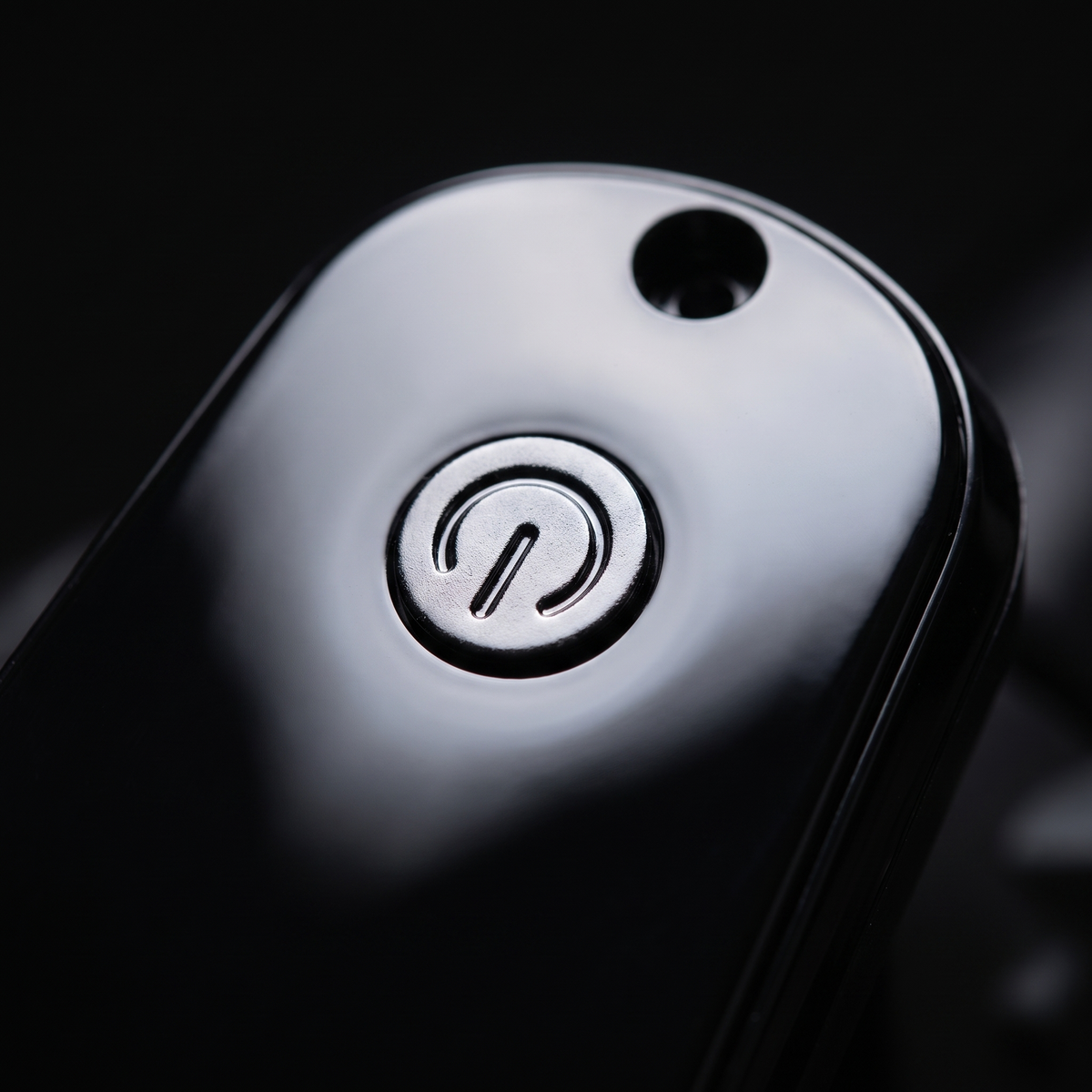 Close up of the recessed power button and sensor hole on the Inmotion Climber display
