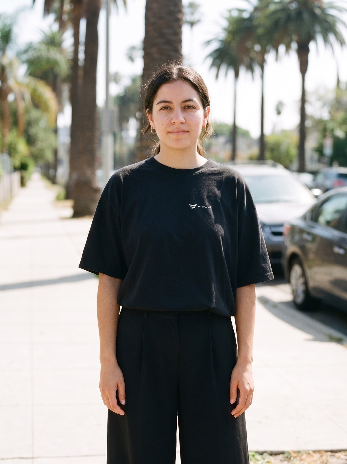 YVolt Logo Tee in black worn by a woman, YVolt logo printed on the left chest