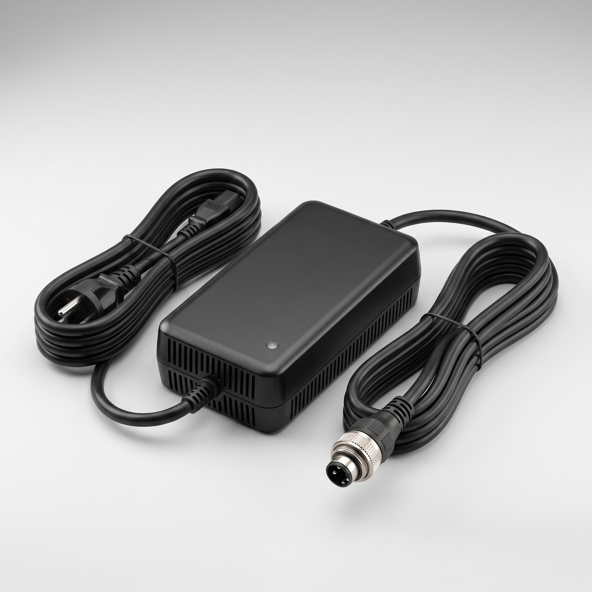 48V 3A charger for the Aptum VM 1 with both cables coiled and the three pin output connector