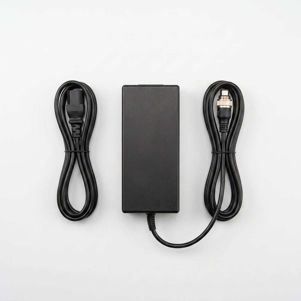 48V 3A VM 1 charger viewed from above with both cables coiled neatly