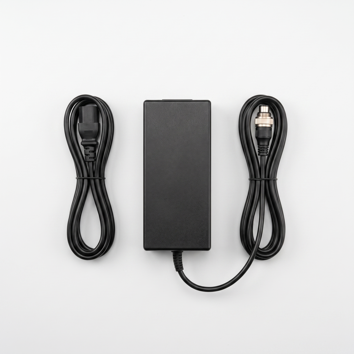 48V 3A VM 1 charger viewed from above with both cables coiled neatly