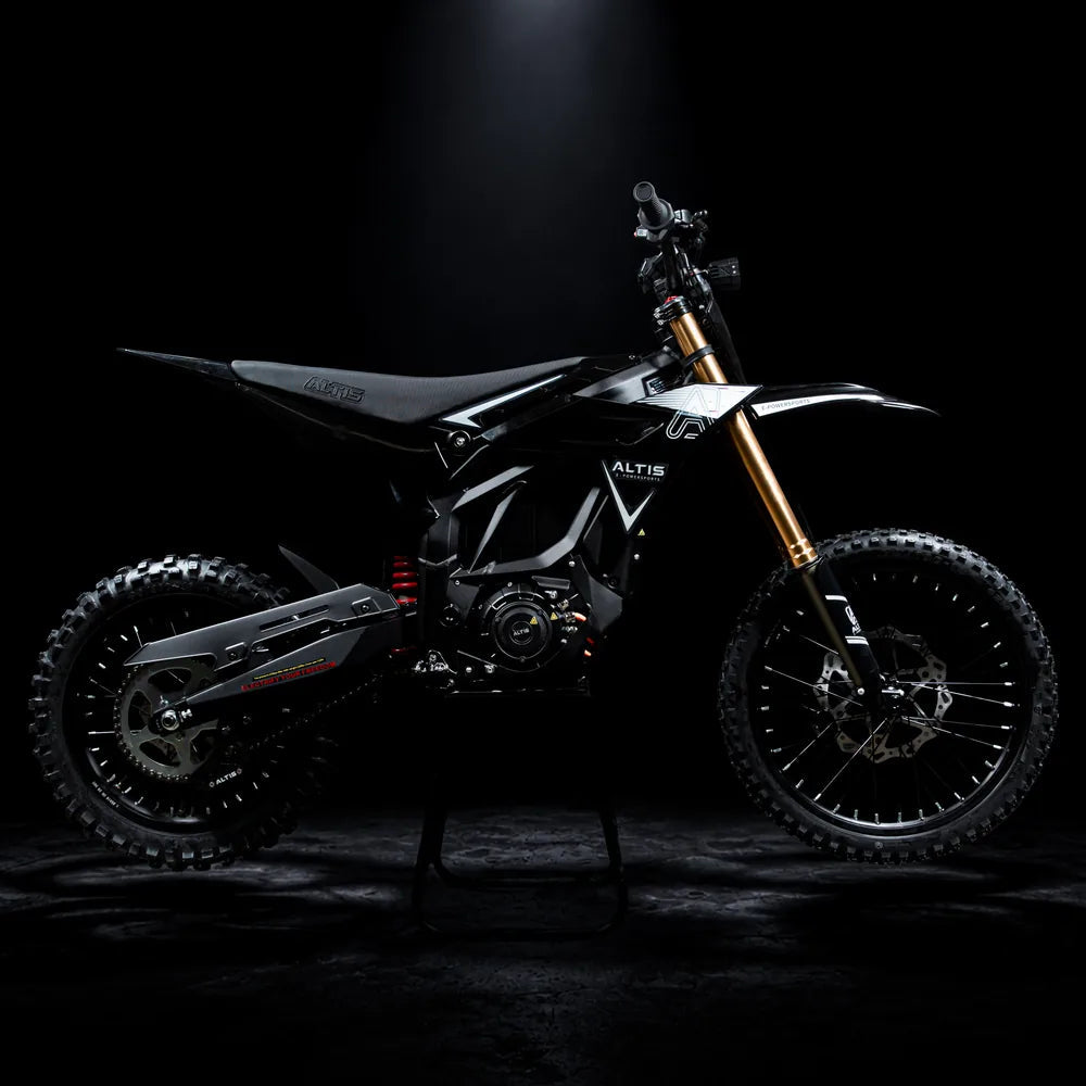 2027 Altis Sigma electric dirt bike in black, side profile facing right, with gold forks, on a stand in a dark studio
