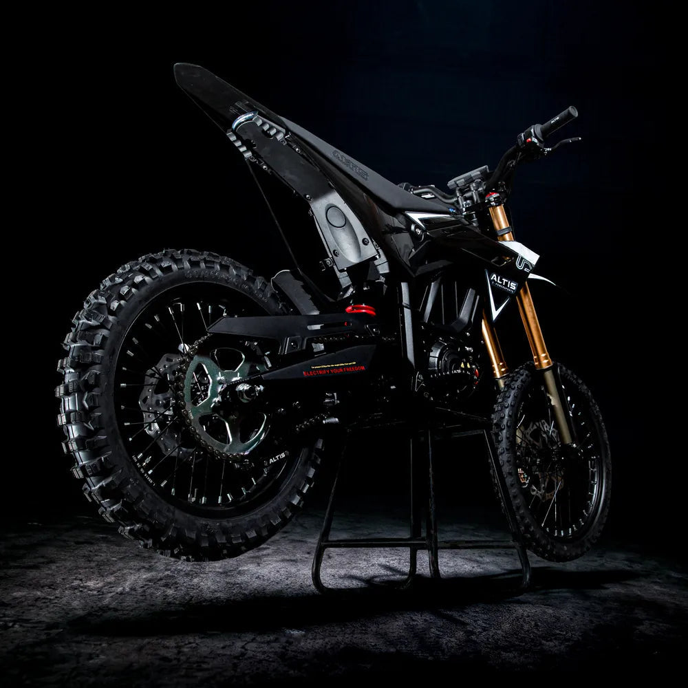 Altis Sigma electric dirt bike from the rear three-quarter angle, showing the knobby rear tire and swingarm