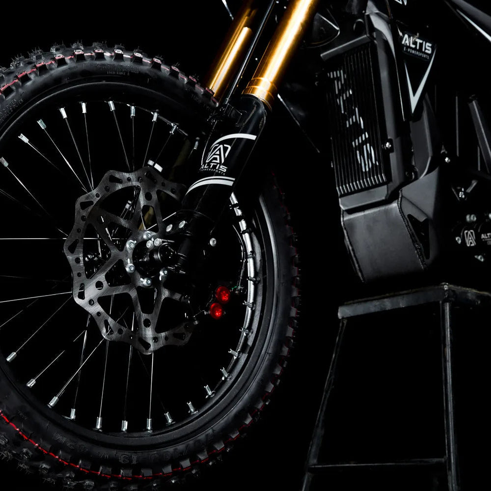 Altis Sigma front wheel with a wave-pattern brake rotor, red caliper bolts and a knobby off-road tire