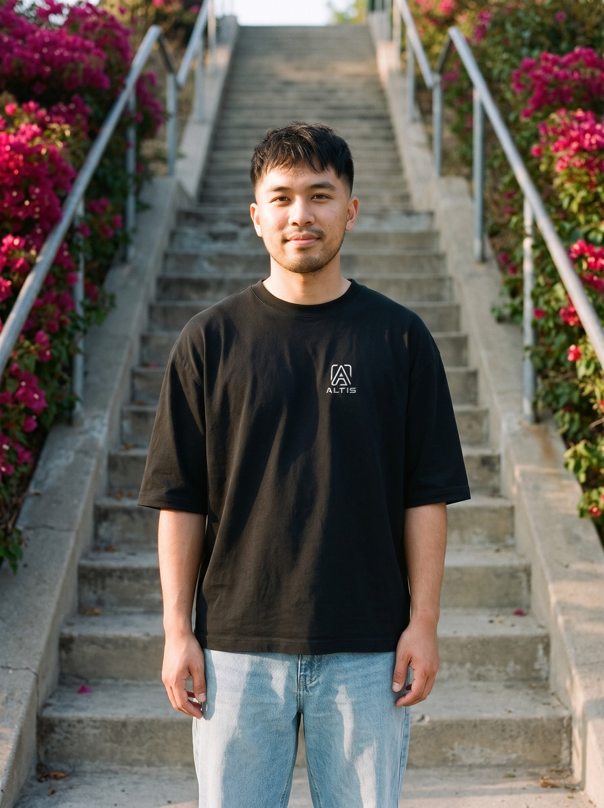 Altis Logo Tee in black worn by a man, Altis logo printed on the left chest