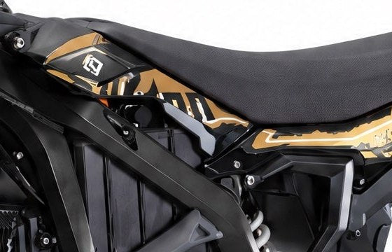 Close view of the Surron Ultra Bee tank shroud decal and badge