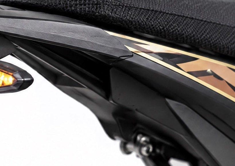 Rear subframe rail of the Surron Ultra Bee under the seat where the grab handles bolt on