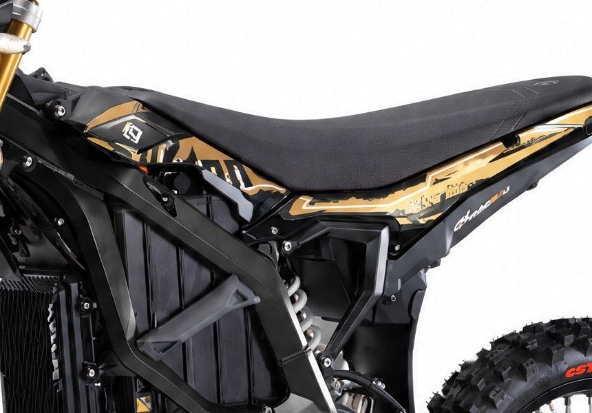 Side fairings fitted on the Surron Ultra Bee, both panels visible under the seat