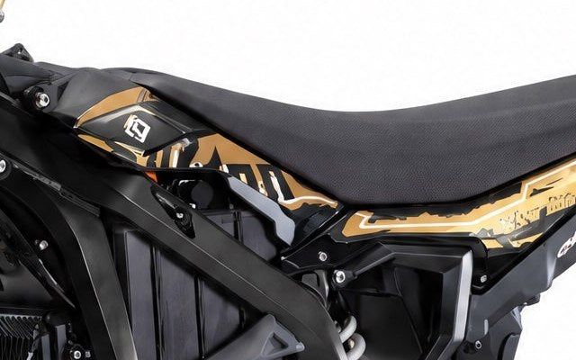 Side fairing panel on the Surron Ultra Bee with the factory gold graphics, close detail