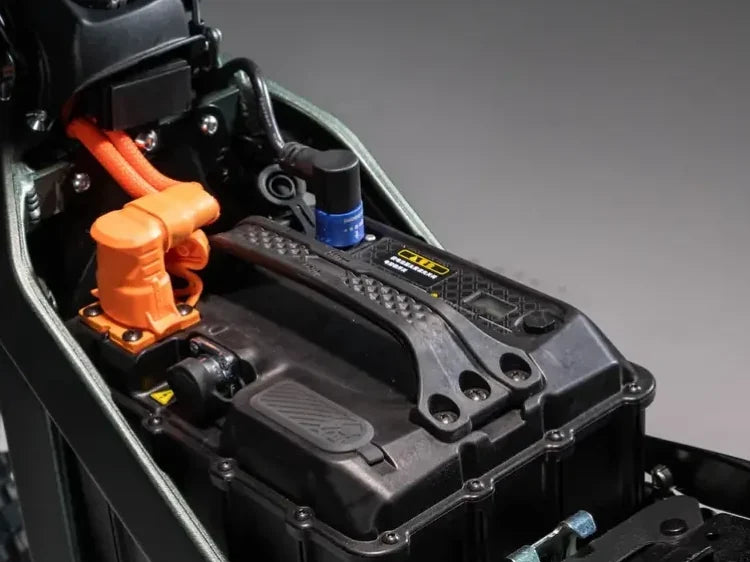 Surron Ultra Bee 74V 60Ah battery under the seat, with its orange main power plug