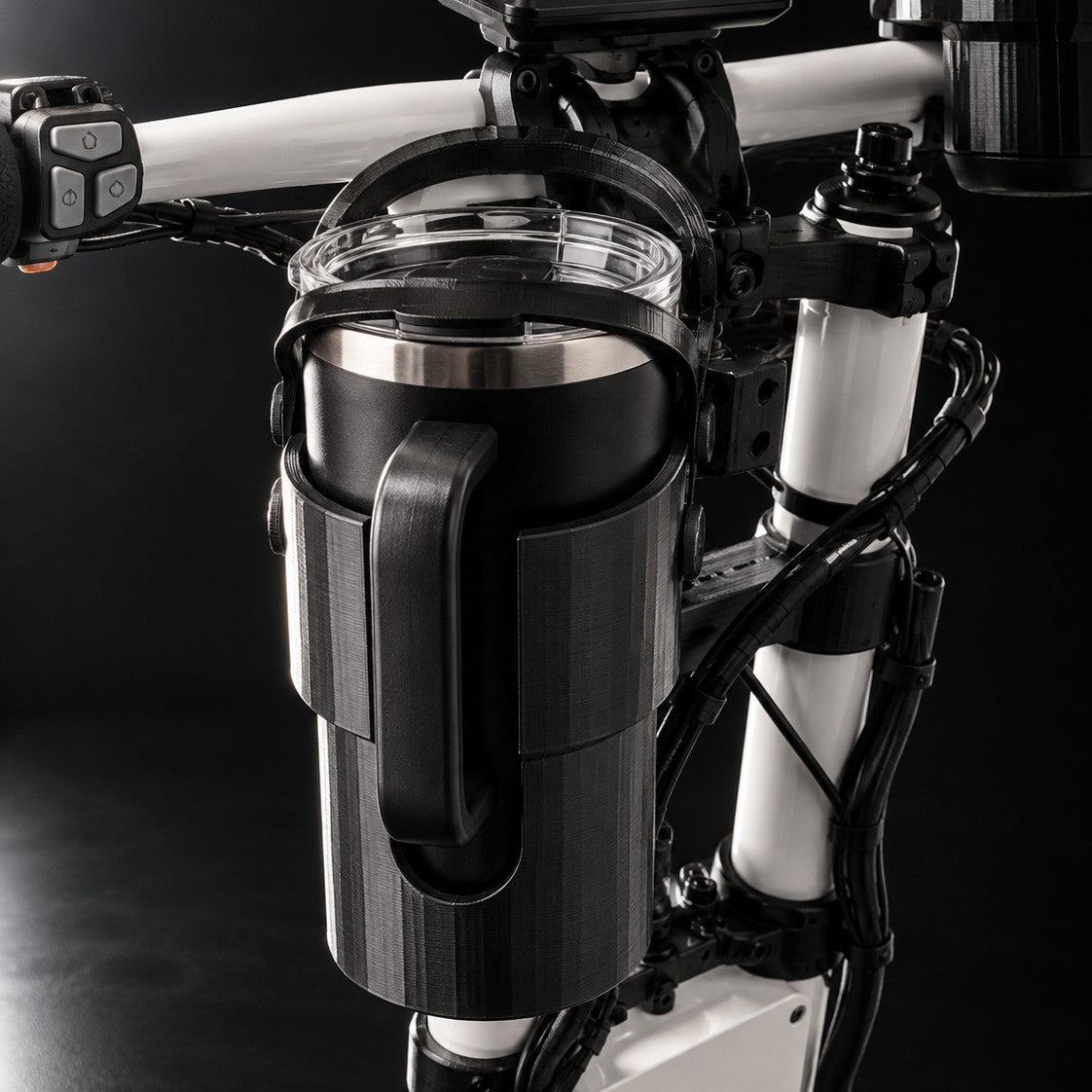 Holder with a tumbler mounted low on the scooter stem near the fork