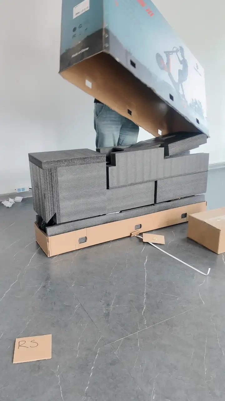 The box lid lifting off the foam